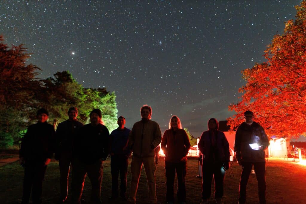a group of stargazers from The Phoenix Astronomical Society at Stardate 2026 under the dark sky or Wairarapa